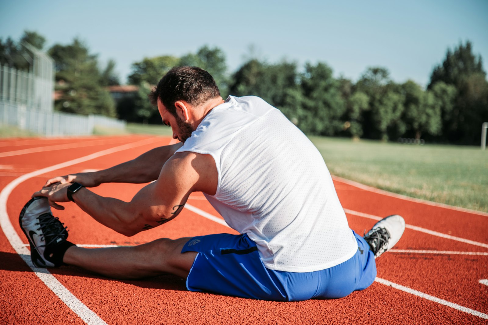 Person stretching on a mat in a bright room
